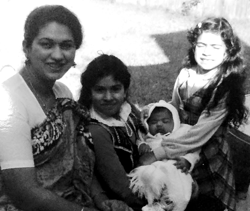 Pree as a baby in Louisiana, held by her sisters and mother