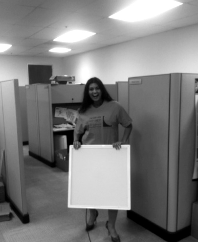 Pree holding a next-generation LED two-by-two panel near her cubicle, 2011